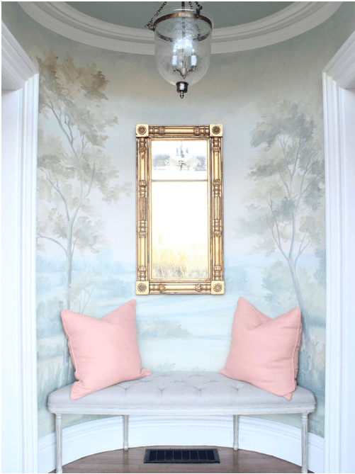 scenic landscape mural on curved entry hall with coral pillows