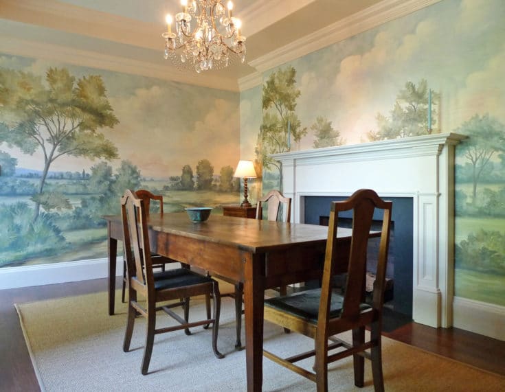 Dining room with fireplace and scenic mural wallpaper