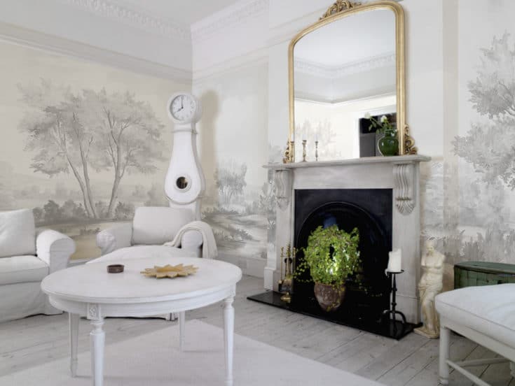 Clean white living room with gray scenic mural wallpaper