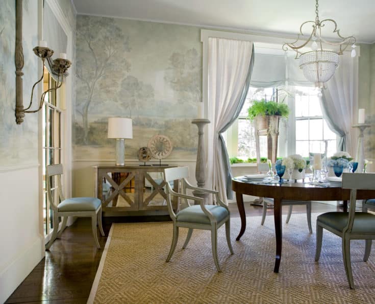 traditional dining room with a chandelier, mint green chairs, and misty landscape mural wallpaper