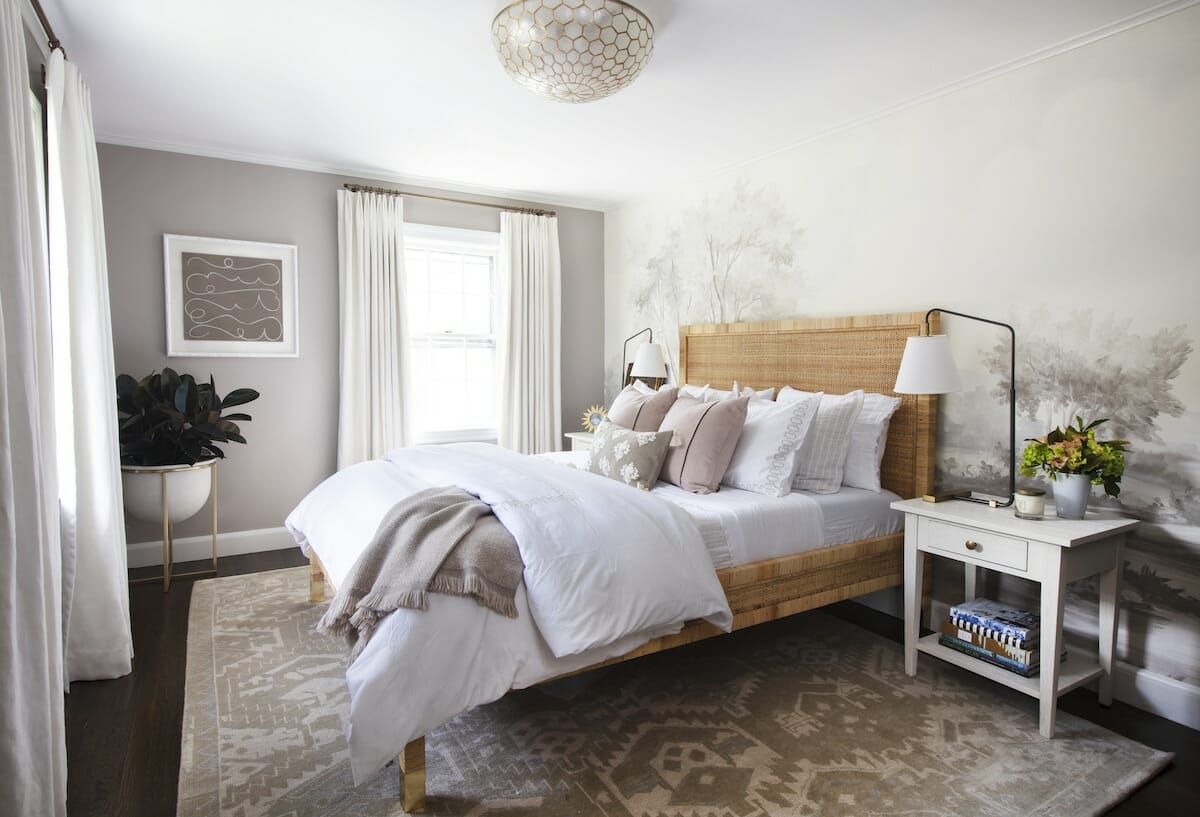 Bright bedroom with grisaille mural wallpapaer, rattan bed frame, modern design globe light fixure