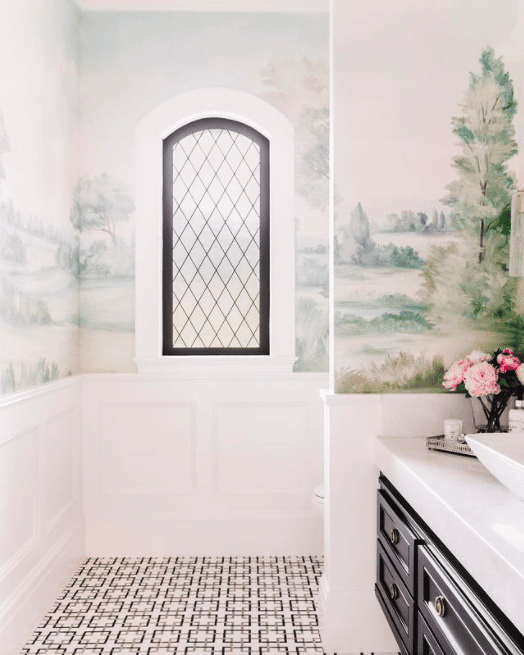 modern powder room with black and white elements and a colorful landscape mural